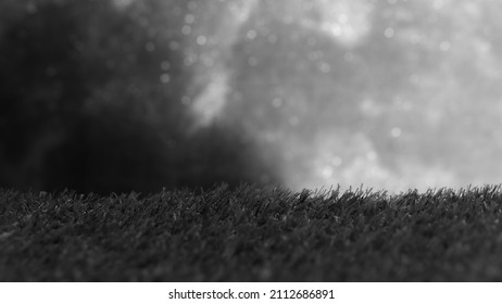 Artificial Grass for a Product Display, Showing Close Detail to the Fake Surface on a Blurred Bokeh Balls Background.