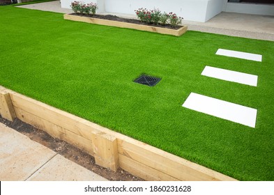 Artificial grass/lawn turf in the front yard of a modern home/residential house. - Shutterstock ID 1860231628