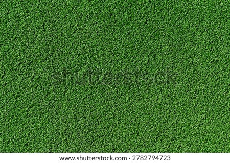 Artificial green grass texture background. Close up of synthetic turf pattern for soccer field or golf course.