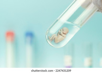 Artificial insemination. Test tube baby, IVF. A human embryo in a glass tube on a blue laboratory background. The concept of artificial insemination or human cloning. - Shutterstock ID 2247431209