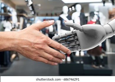 Artificial Intelligence (AI) Advisor Or Robo-adviser In Smart Retail Technology. Shaking Hands Of Male Executive Director And 3d Rendering Robot. Blur Fashion Retail Mall Background.