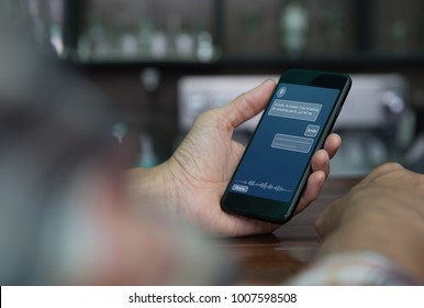 Artificial intelligence, Ai concept, casual man using mobile smart phone with chatbot application on screen in coffee shop, chat bot, social media, internet network communication - Shutterstock ID 1007598508