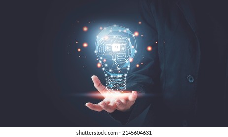 Artificial intelligence (AI) concept. Hand hold brain with shining wireframe, Neural networks in light bulb of business networking technology innovation. - Shutterstock ID 2145604631