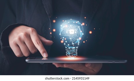 Artificial intelligence (AI) concept. Hand touch tablet brain with shining wireframe, Neural networks in light bulb of business networking technology innovation.