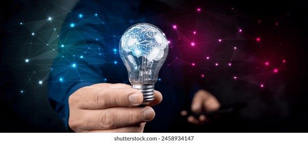 Artificial intelligence (AI) concept. Hand hold brain with shining wireframe, Neural networks in light bulb of business networking technology innovation. - Powered by Shutterstock