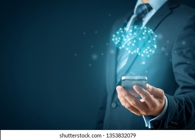 Artificial intelligence (AI), machine deep learning, data mining, and another modern computer technologies concepts. Brain with PCB design representing AI and businessman holding smart mobile phone.