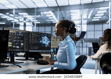 Artificial intelligence data center expert writing disaster recovery plans ensuring minimal downtime. African american server farm worker uses analytics to predict needed equipment upgrades