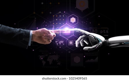 artificial intelligence, future technology and business concept - robot and human hand with flash light and virtual screen projection over black background - Shutterstock ID 1025409565