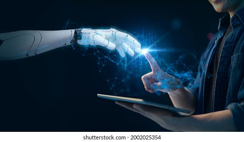 Artificial intelligence, futuristic digital technology robot and man hand finger pointing touch data transfer, NFT, metaverse, crypto, blockchain, internet cyber security VPN network solution - Shutterstock ID 2002025354