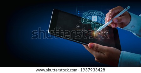 Artificial intelligence of futuristic technology concept. Hand using an electronic pen write on tablet screen virtual circuit AI brain genius technology.