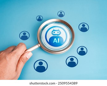 Artificial Intelligence jobs, robot career, human resource (HR), hiring, recruitment concept. AI bot icon selected by magnifying glass lens in human hand on blue background with people symbols. - Powered by Shutterstock