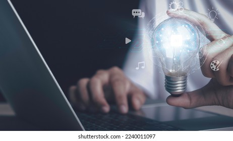 Artificial intelligence machine learning concept. Human hand hold digital brain of AI in light bulb be a help think creativity idea Music, Movie, Chat bot. Analytics big data around the world.