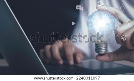 Artificial intelligence machine learning concept. Human hand hold digital brain of AI in light bulb be a help think creativity idea Music, Movie, Chat bot. Analytics big data around the world.