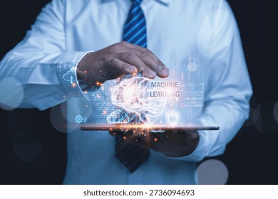 Artificial Intelligence and Machine Learning Technology Concept. A businessman holds a tablet displaying a virtual screen of a brain with artificial intelligence AI, and machine learning.