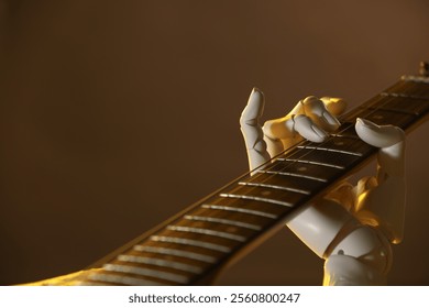 Artificial intelligence. Robot hand playing guitar on brown background, closeup
