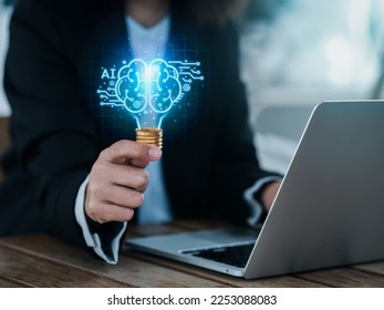 Artificial intelligence technology concept. Glow digital light bulb graphics with AI brain system inside, hold by business person. Creative innovation and idea learning with future smart technology. - Powered by Shutterstock - Get 15% off with code: PIKWIZARD15