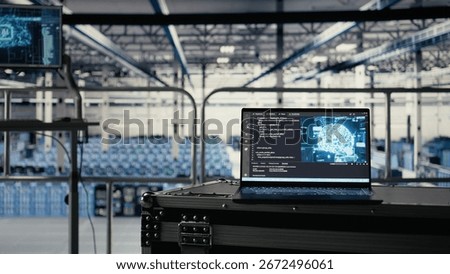 Artificial intelligence technology on notebook in industrial data center facility helping power internet services. AI coding script running on laptop in server farm built for digital storage systems