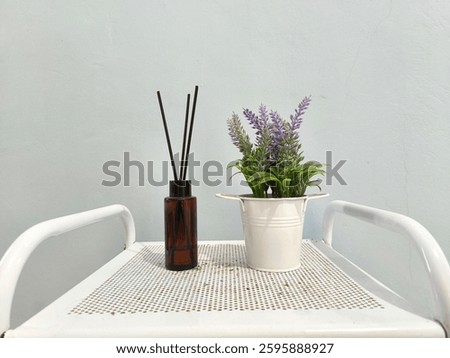 Artificial lavender flower arrangements and diffusers as room decoration elements.