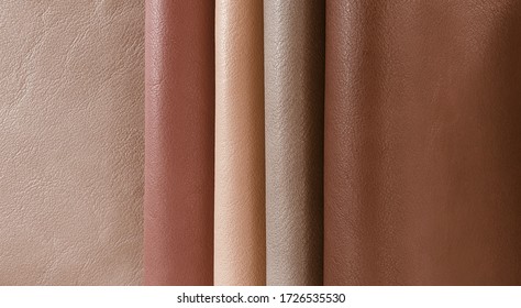 Artificial leather in variety shades of brown colors in classic mood. abstract brown leather sample catalog background.