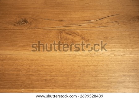 Artificial light projects openwork patterns onto light-colored wooden planks, creating a play of light and shadow that changes with the viewing angle