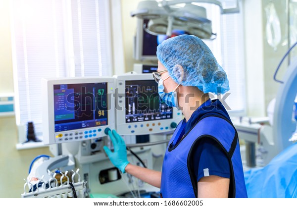 Artificial lung\
ventilation monitor in the intensive care unit. Nurse with medical\
equipment. Ventilation of the lungs with oxygen. COVID-19 and\
coronavirus identification.\
Pandemic.