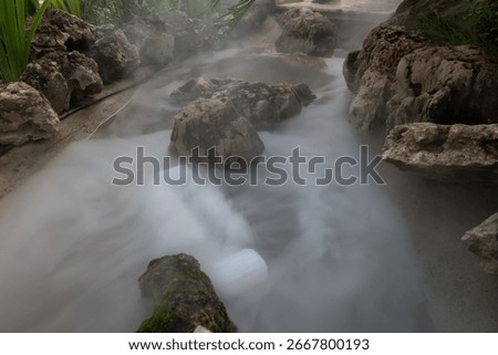 Artificial mist flows gently through rock-lined channels in the landscaped garden of TakeTime Glamping, Saraburi, Thailand, on August 11, 2025.