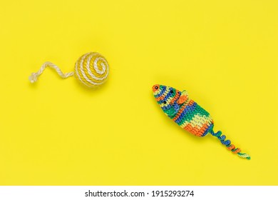 Artificial Mouse And Ball For Playing Cats On A Bright Yellow Background. View From Above. Colorful Pet Toys