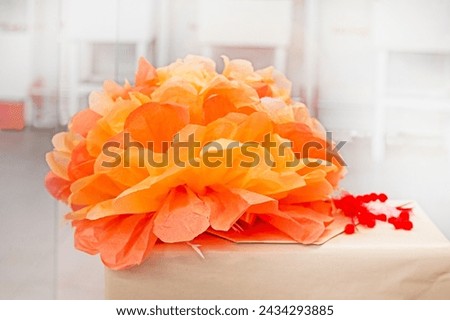 artificial orange flower made of corrugated paper. Gift wrap