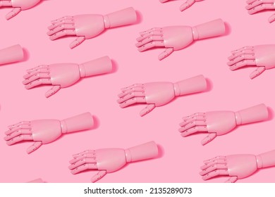 Artificial pattern with pink mannequin  hands on pink background. Minimal creative futuristic concept.