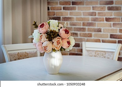 Artificial Peonies Flowers In White Ceramic Vase On White Table. Classic Interior At Home.
