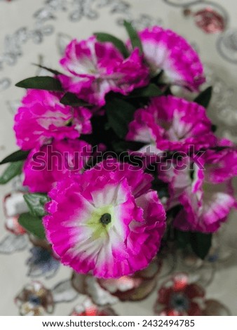 Artificial pink amd white flowers in flower wase 