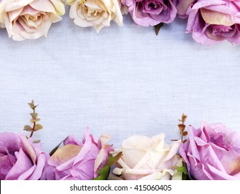 Artificial Purple Rose Flowers On Linen Copy Space Border Background