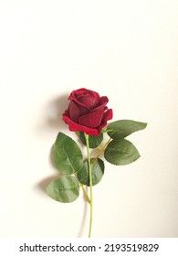 Artificial red rose flower. Isolated background in white.