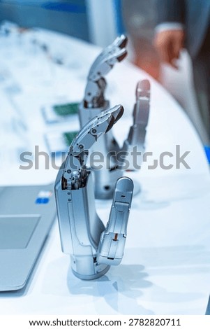 Artificial robotic hand at the presentation of robotics background.Creation of artificial intelligence
