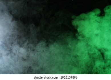 Artificial smoke in red-green light on black background