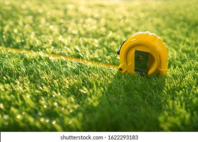 Artificial turf background with measuring tape