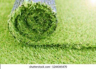 Artificial Turf Roll. Synthetic Grass Lawn Laying Background. 