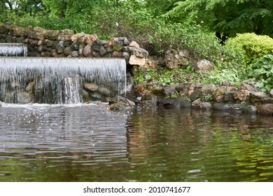 artificial waterfall in public park . High quality photo