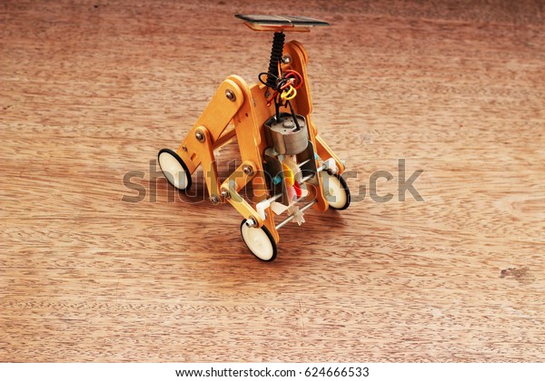 Artificial wood car using solar panels placed
on a brown
background