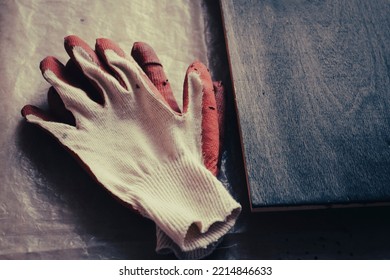 Artisan Background - Work Gloves On Polyethylene Oilcloth And Painted Plywood.