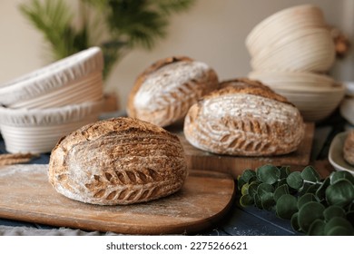 Artisan Batard Sourdough healthy Bread with leaf scoring. Open crumb high hydration Sourdough bread set on white table.