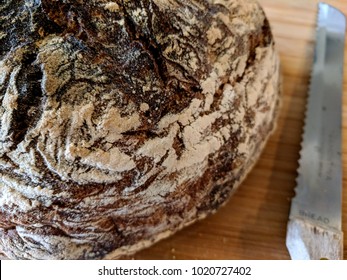 Artisan Bread On Cutting Board Next To Knife