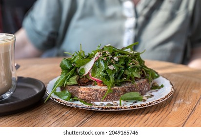 Artisan Bread Sandwich With Arugula, Radish And Avocado Salad. Vegan Breakfast. Selective Focus.