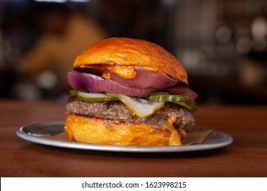 Artisan Burger In Bar At Happy Hour.