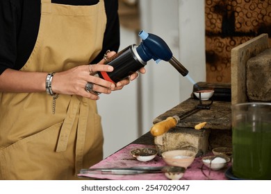 An artisan carefully uses a torch to create stunning jewels, showcasing craftsmanship in action. - Powered by Shutterstock