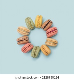 Artisan Chef Minimal Concept. Yummy Macarons Arranged In A Circle. Flat Lay Arrangement With Pastel Blue Background