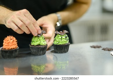 Artisan Chef Preparing Handmade With Icing And Chocolate Spider Vampire Topper