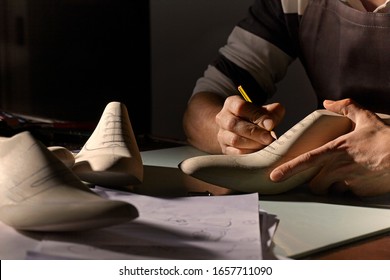 Artisan designing leather men shoes. - Powered by Shutterstock