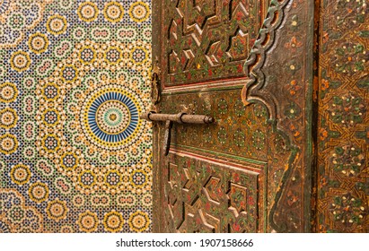 artisan door with handle and lock opening to room with mosaic