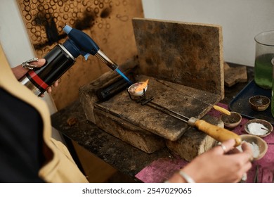 An artisan expertly uses a torch to heat metals while creating stunning jewelry pieces. - Powered by Shutterstock